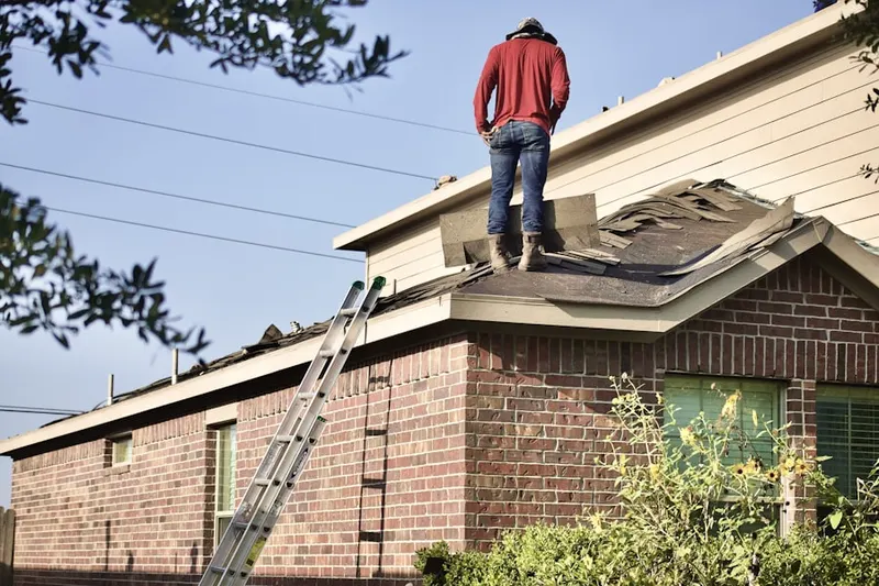 Professional roofer working on a residential roof in Hood River